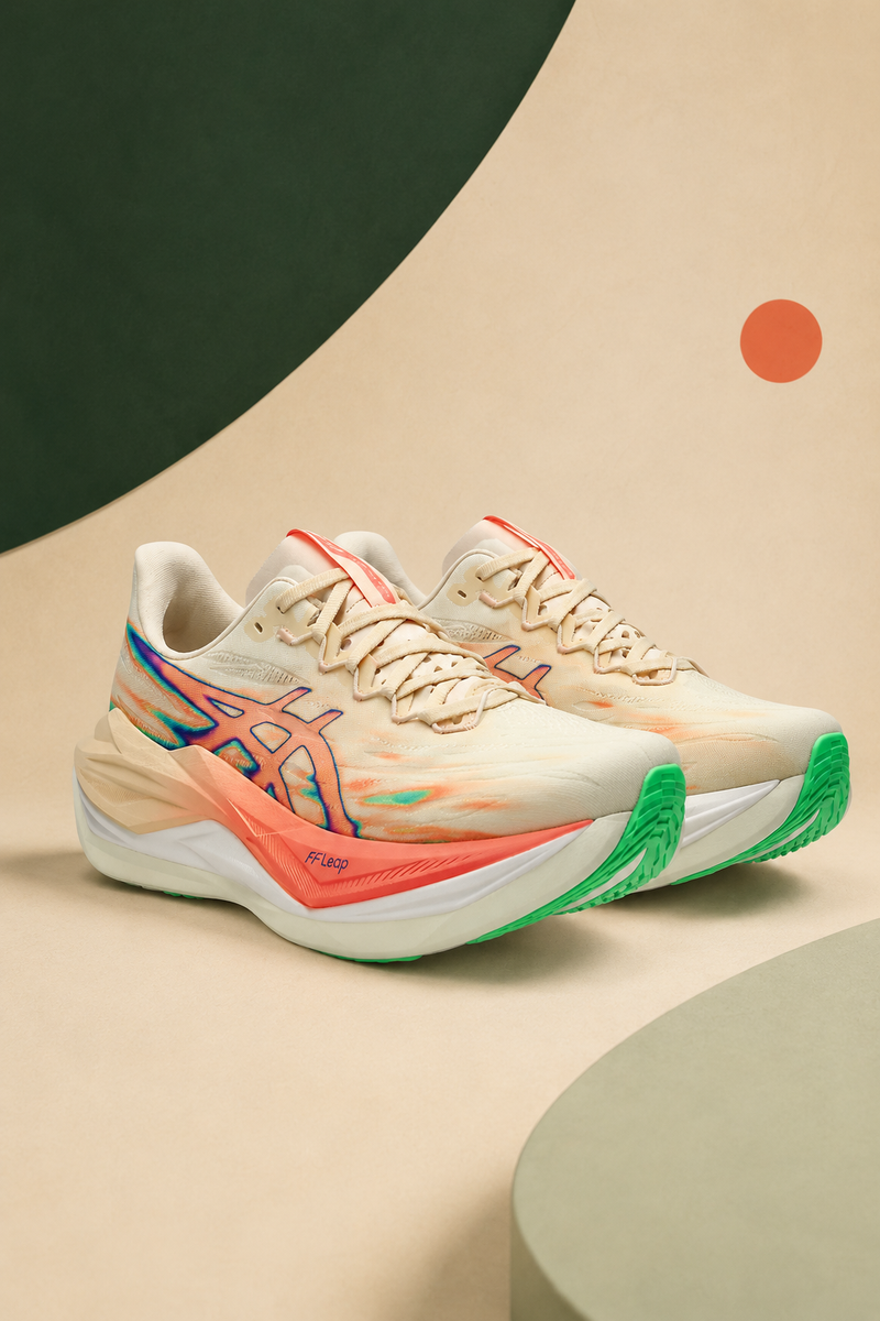 Pair of Seashell and Sun Coral ASICS Superblast 3 running shoes on a cream and forest-green Verdosa background