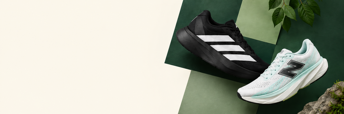 Black Adidas and mint New Balance running shoes against forest green and sage panels